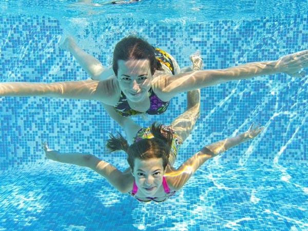 Girls enjoying swimming after a pool filter repair in Corona, CA